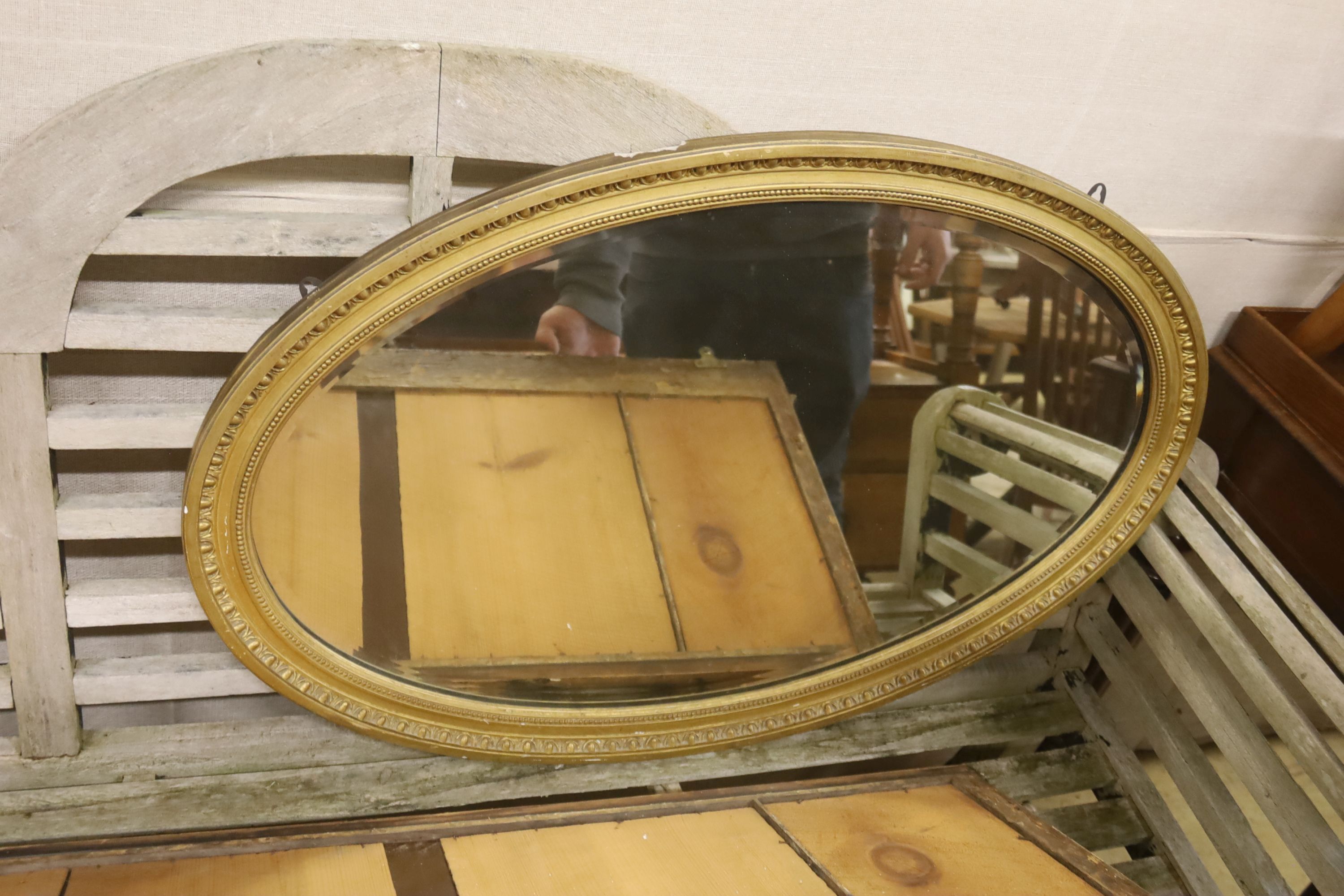 A Regency giltwood and gesso triple plate overmantel mirror, width 129cm, height 51cm, together with a later oval wall mirror
